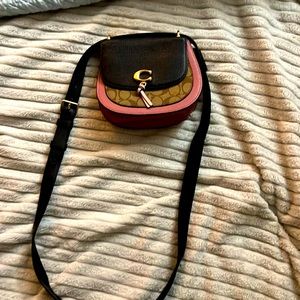 This is a purple, pink, and brown crossbody from coach